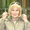 Sylvia trying on a string of mixed quartz stones.